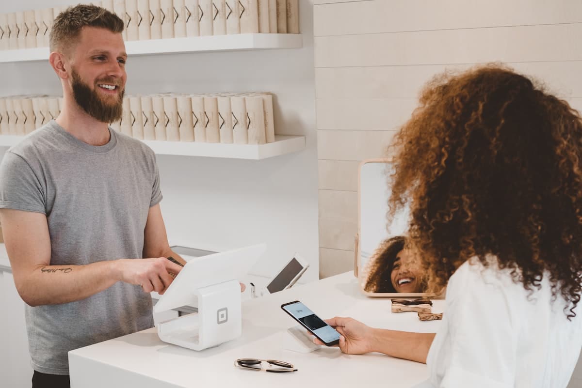 Kunde zahlt mit dem Smartphone am Kartenterminal